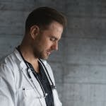 Man in White Button Up Shirt Holding Black Tablet Computer